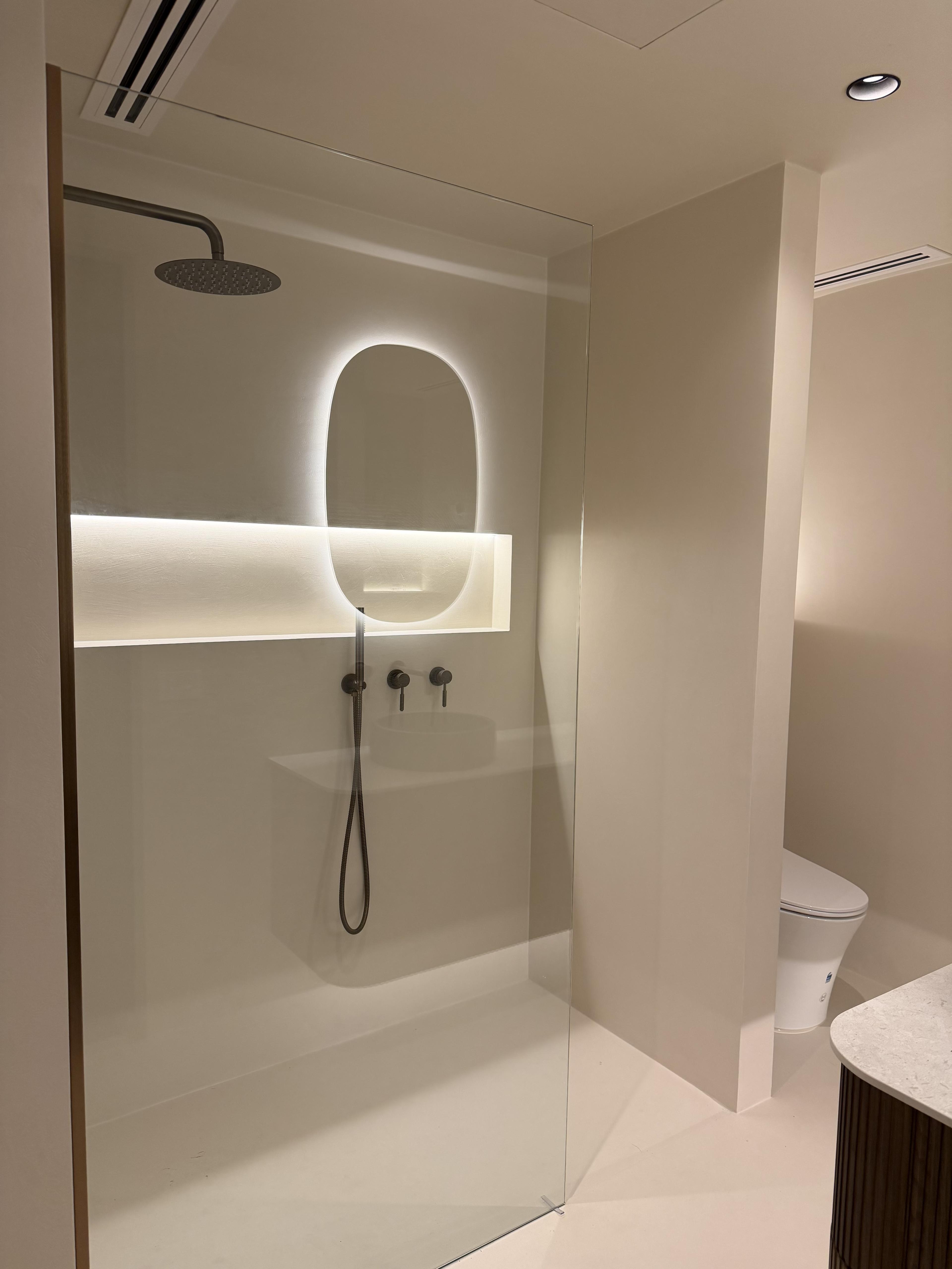 Microcement bathroom with floor-to-ceiling seamless finish and custom textured walls — St Kilda Penthouse