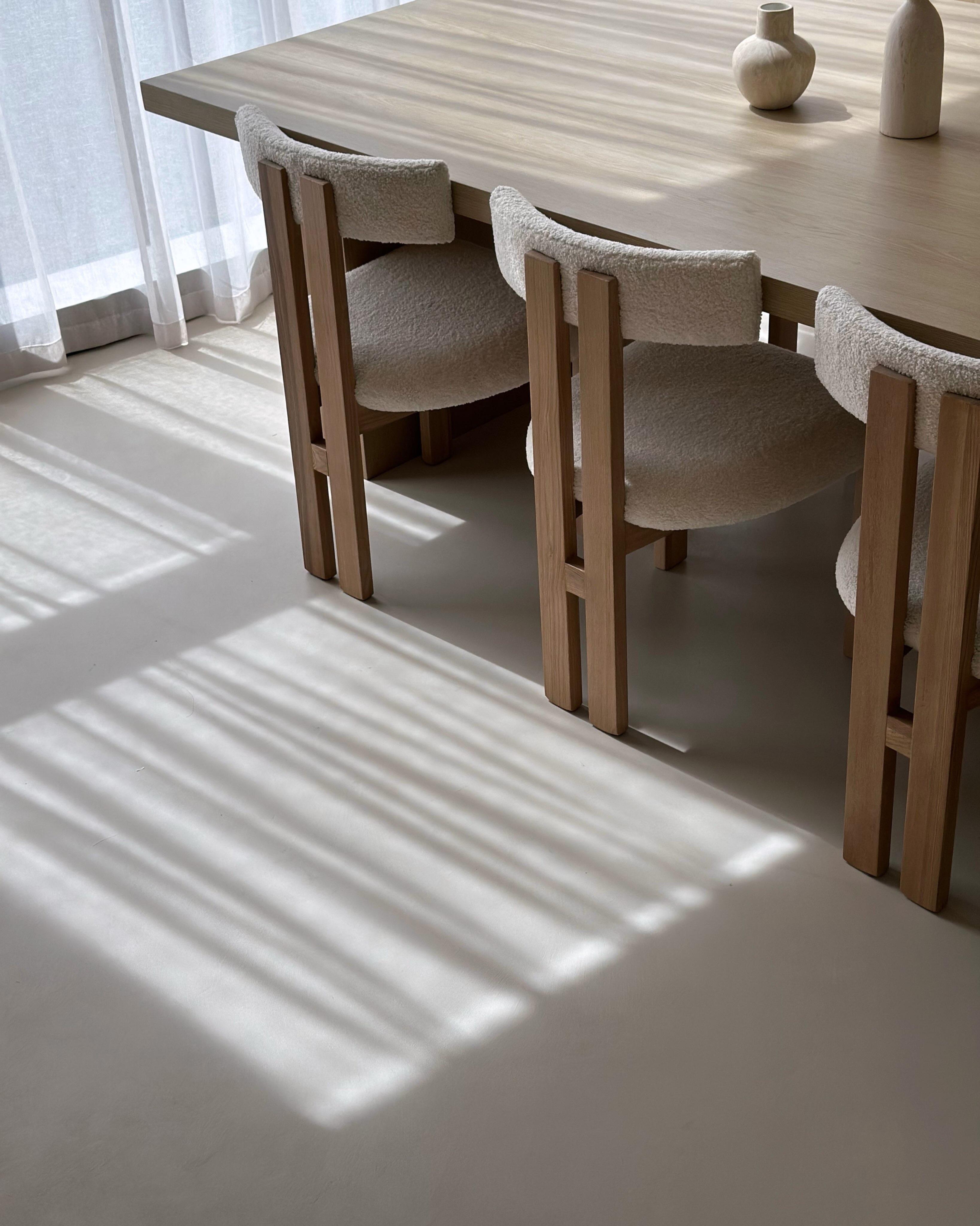 Seamless microcement floor finish in Toorak providing a blank canvas for furniture — calm neutral tone throughout